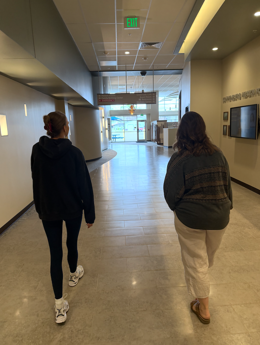 Two women walking in a hallway